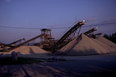 Low angle view of mining machinery against sky 