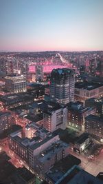 High angle view of illuminated city buildings against clear sky