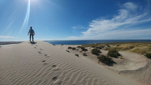 Full length of man on beach against sky