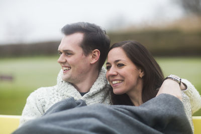 Young couple outside sitting together in a garden