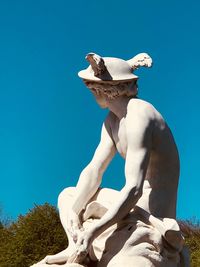 Low angle view of statue against clear blue sky