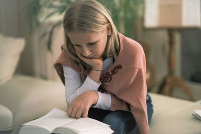 Midsection of woman reading book