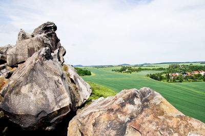 Rocks on landscape against sky