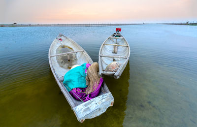 Boat moored in sea against sky