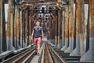 Man standing on railroad track