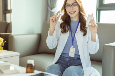 Young woman smiling while sitting at home