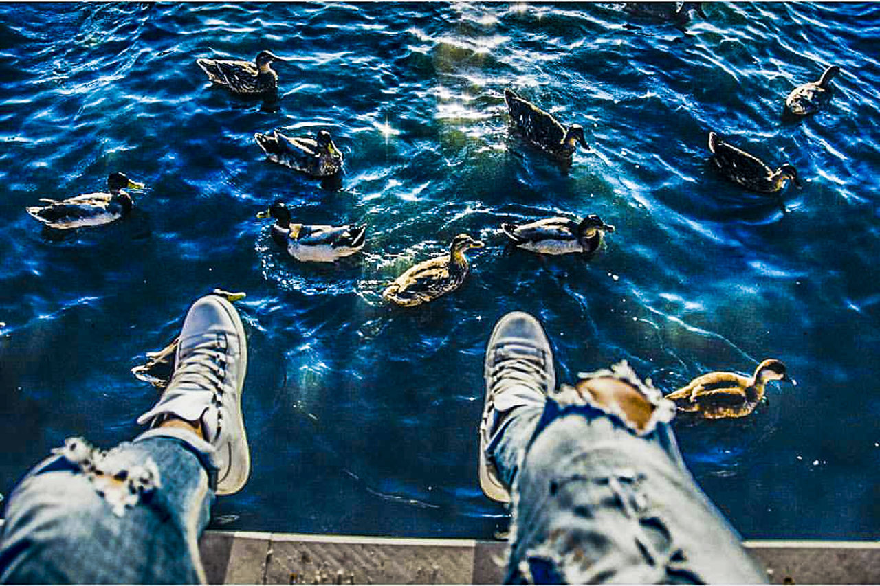 LOW SECTION OF MAN RELAXING ON DECK