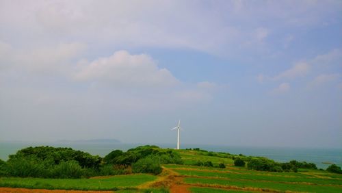 Scenic view of farm against sky