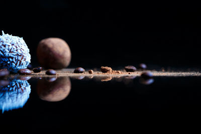 Close-up of fruits on table against black background