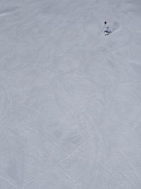 High angle view of person skiing downhill on snow