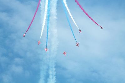 Low angle view of airshow against sky