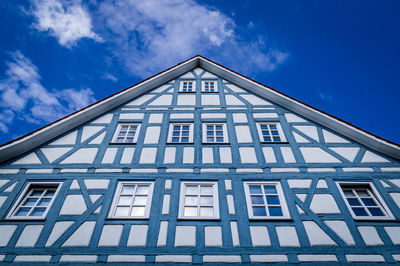 Low angle view of house against blue sky