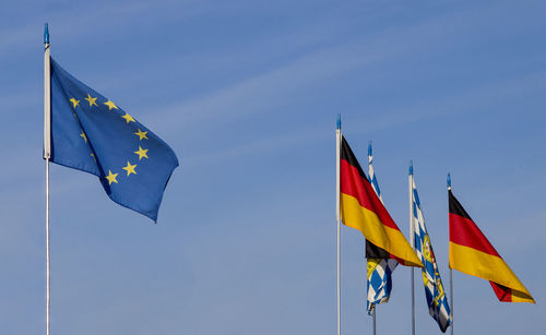 European flag with germany and bavarian flags in front of blue sky