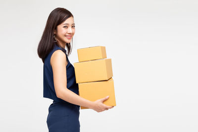 Portrait of a smiling young woman over white background