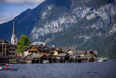 Houses by sea against mountain