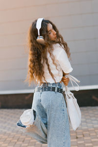 Low angle view of young woman looking away