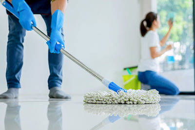 Low section of man working on floor