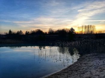 Scenic view of lake against sky during sunset