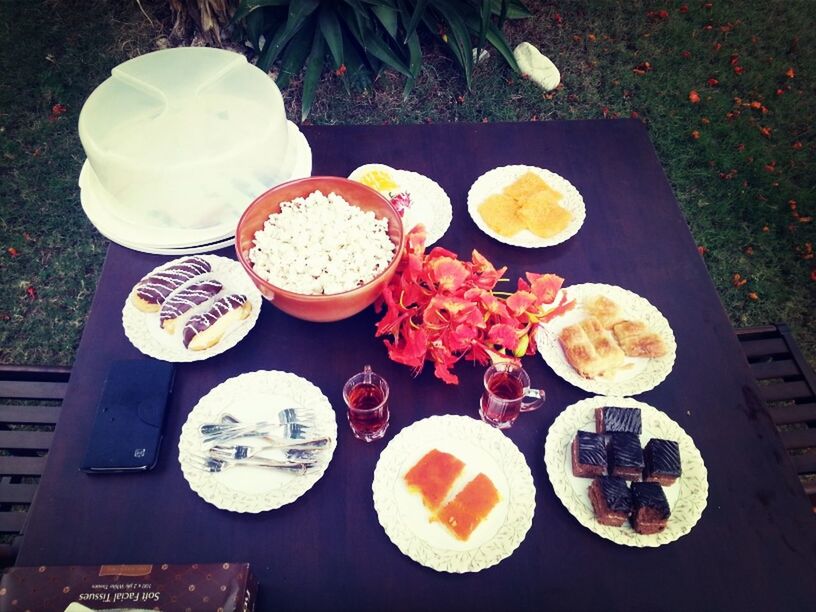 food and drink, high angle view, food, freshness, table, indoors, still life, plate, healthy eating, directly above, ready-to-eat, variation, bowl, no people, wood - material, drink, sweet food, arrangement, choice, indulgence