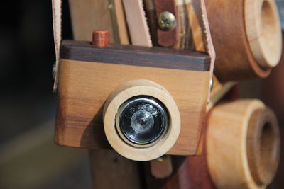 Close-up of wooden cameras hanging at store