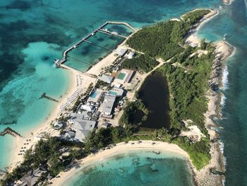 High angle view of swimming pool by sea against buildings