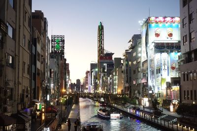 Canal amidst buildings against sky in city