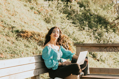 Portrait of smiling young woman using mobile phone