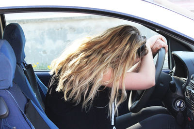 Portrait of woman sitting in car