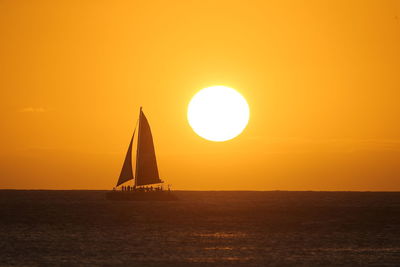 Scenic view of sea against orange sky during sunset