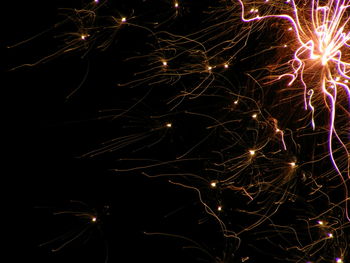 Low angle view of firework display at night