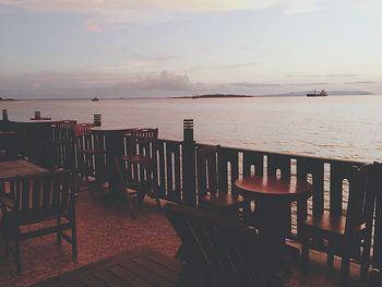 Pier on sea at sunset