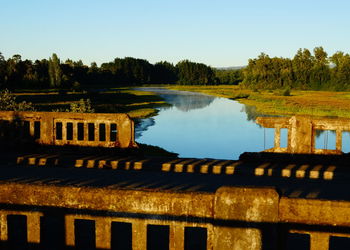 Built structure in river against sky