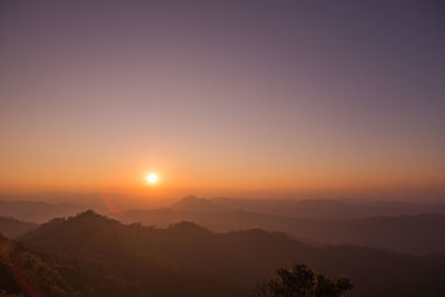 Scenic view of silhouette mountains against sky at sunset