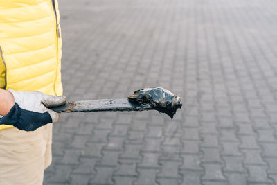 Cropped hand of man holding metal