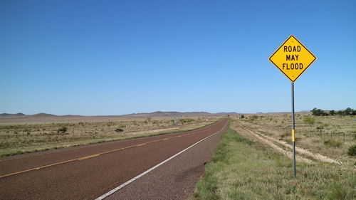 Road sign against clear sky