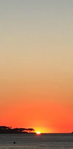 Scenic view of sea against romantic sky at sunset