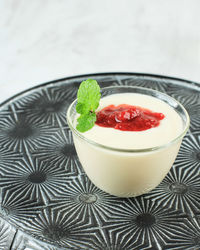 Strawberry panna cotta on mini bowl, italian traditional dessert with jelly and strawberry compote