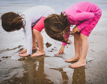 Siblings playing at beach