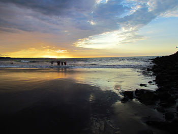 Scenic view of beach against sky during sunset