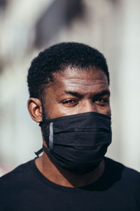 Close-up portrait of young man covering face