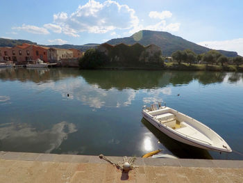 Scenic view of lake by mountains against sky