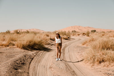 Full length of man on desert against clear sky