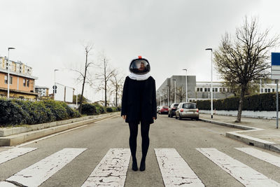 Full length of man standing on road in city