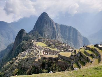 Panoramic view of mountains against cloudy sky