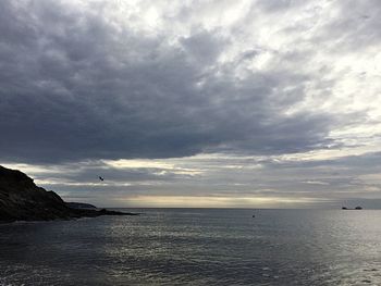 Scenic view of sea against cloudy sky