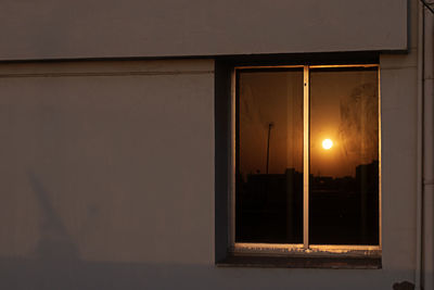 Illuminated building seen through window