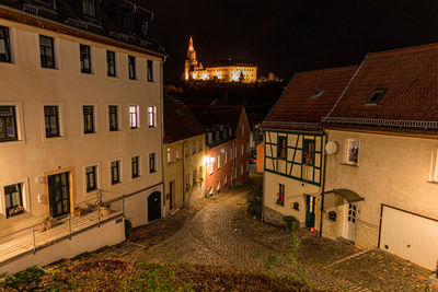 High angle view of street amidst buildings at night