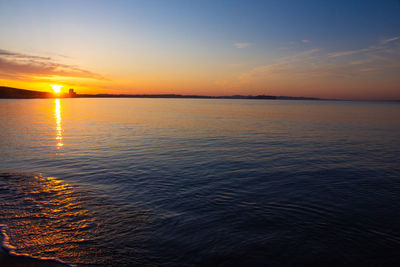 Scenic view of sea against romantic sky at sunset