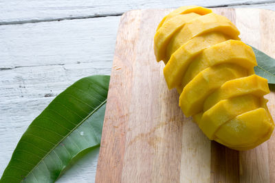 Close-up of mango slices on cutting board