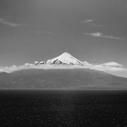 Scenic view of mountains against cloudy sky